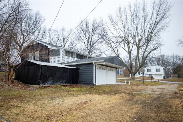 view of property exterior featuring a garage and a yard