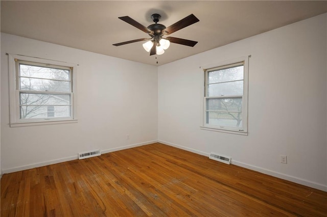 spare room with hardwood / wood-style floors and ceiling fan