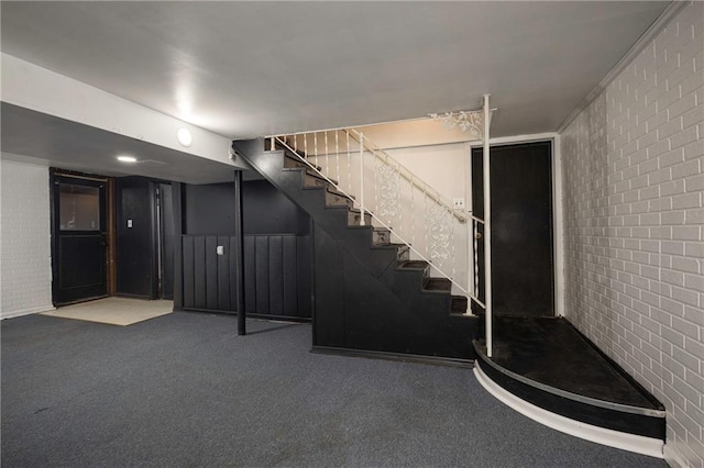 basement with brick wall and carpet flooring