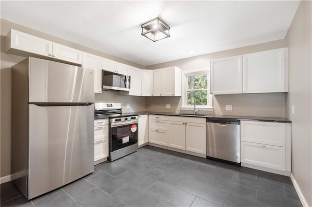 kitchen with white cabinetry, appliances with stainless steel finishes, and sink