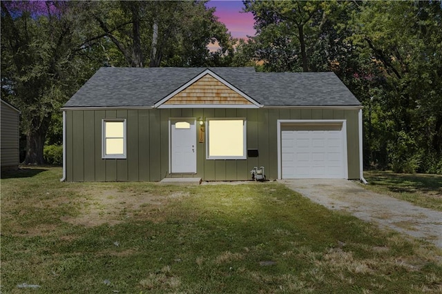 view of front of house featuring a garage and a yard