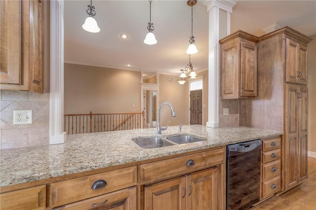 kitchen with pendant lighting, crown molding, sink, light hardwood / wood-style flooring, and light stone countertops