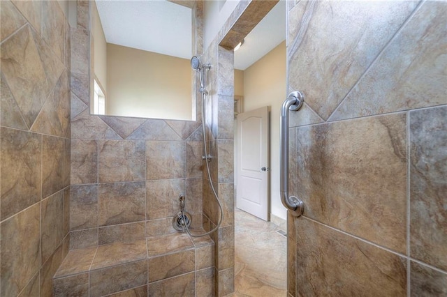 bathroom with a tile shower