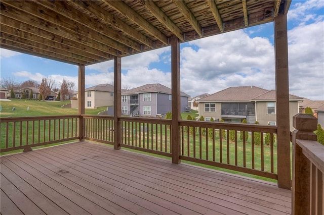 wooden terrace featuring a lawn