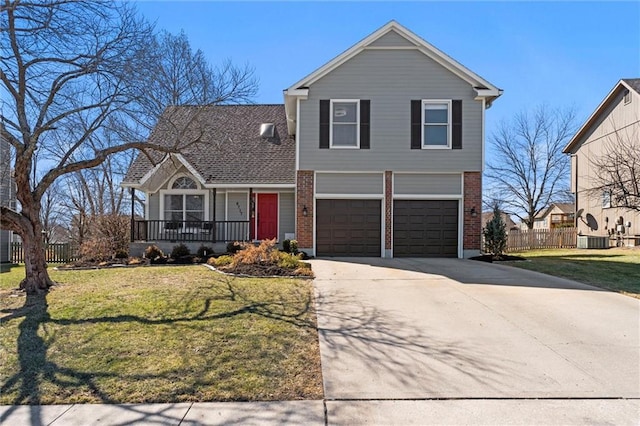 traditional-style house featuring a front yard, brick siding, fence, and driveway