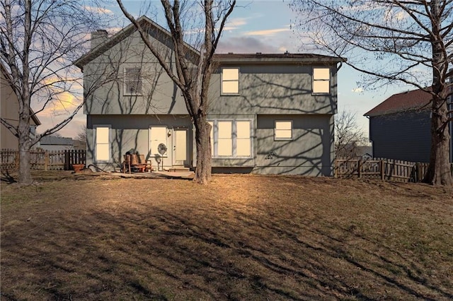 back of house at dusk with fence