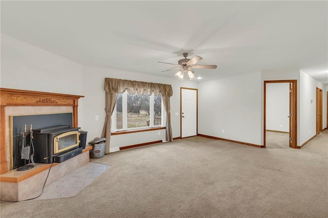 carpeted living room featuring ceiling fan and a wood stove