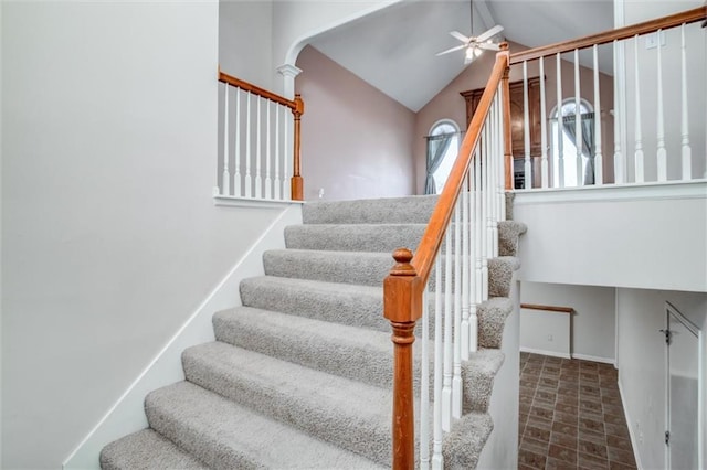 stairs with vaulted ceiling and ceiling fan