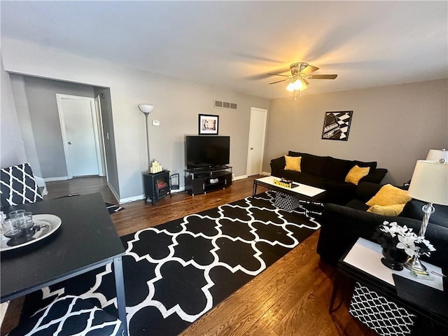 living room with ceiling fan and dark hardwood / wood-style floors