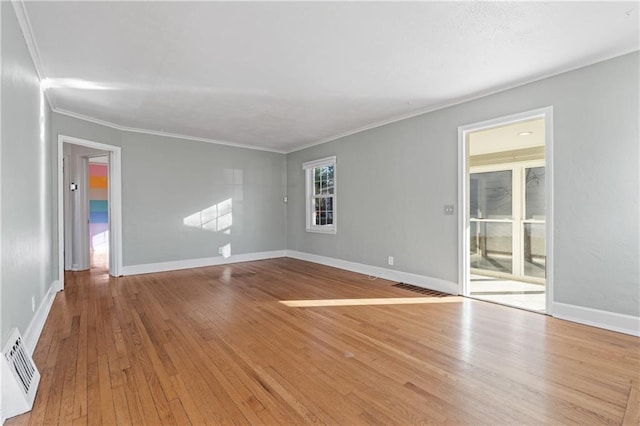 unfurnished room featuring light wood-type flooring and crown molding