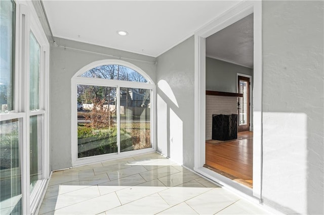 interior space featuring light hardwood / wood-style flooring and crown molding