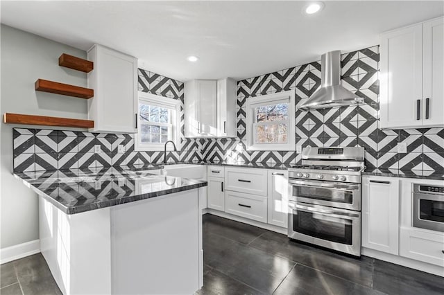 kitchen featuring decorative backsplash, white cabinetry, range hood, and appliances with stainless steel finishes