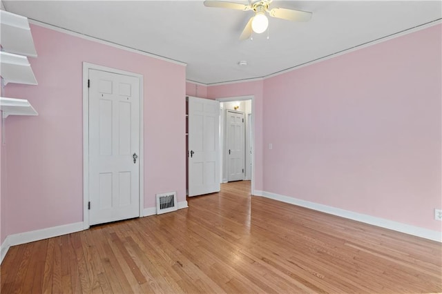 unfurnished bedroom with ceiling fan and light hardwood / wood-style flooring