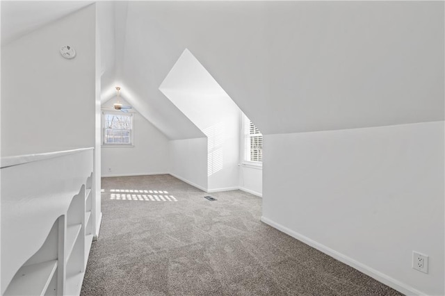 bonus room with carpet flooring, ceiling fan, and lofted ceiling