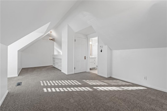 additional living space with carpet floors, ceiling fan, and lofted ceiling