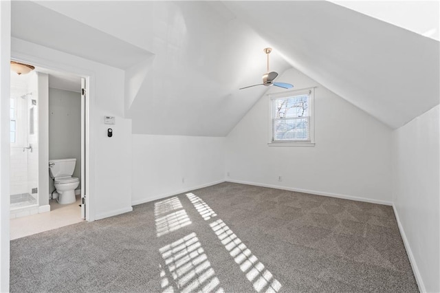 additional living space featuring ceiling fan, light colored carpet, and lofted ceiling