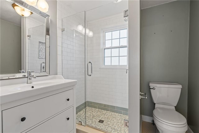 bathroom featuring vanity, toilet, and walk in shower