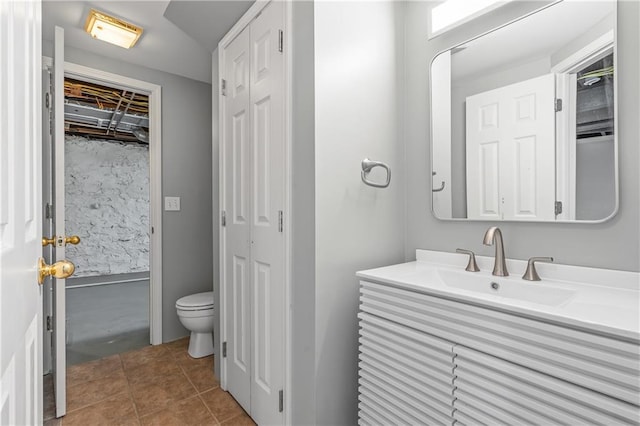 bathroom featuring tile patterned floors, vanity, and toilet