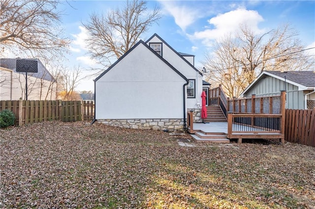 back of house featuring a deck