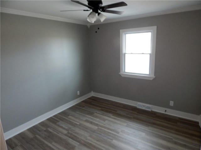 empty room featuring crown molding, dark hardwood / wood-style flooring, and ceiling fan