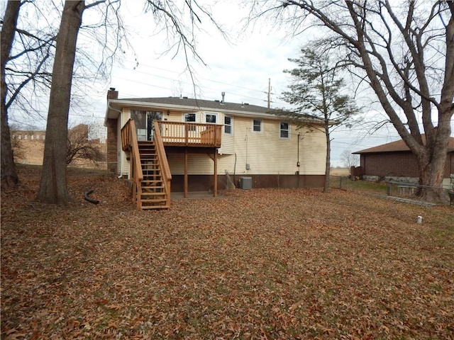 rear view of property featuring cooling unit and a deck