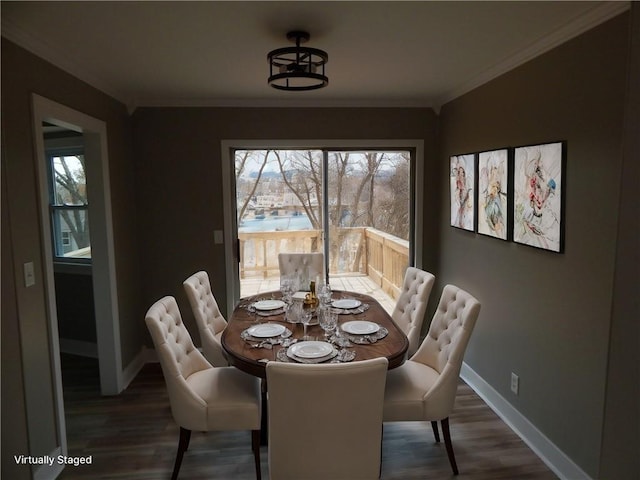 dining space with dark hardwood / wood-style floors and ornamental molding