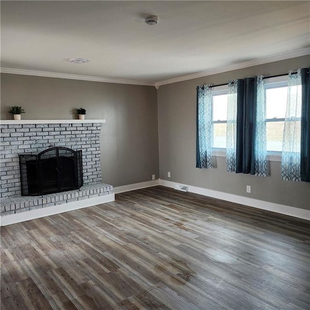 unfurnished living room featuring crown molding, a fireplace, and dark wood-type flooring