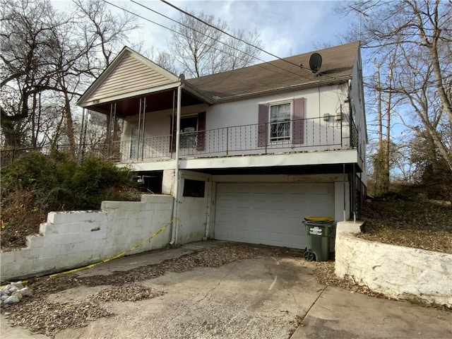 view of front of property with a balcony and a garage