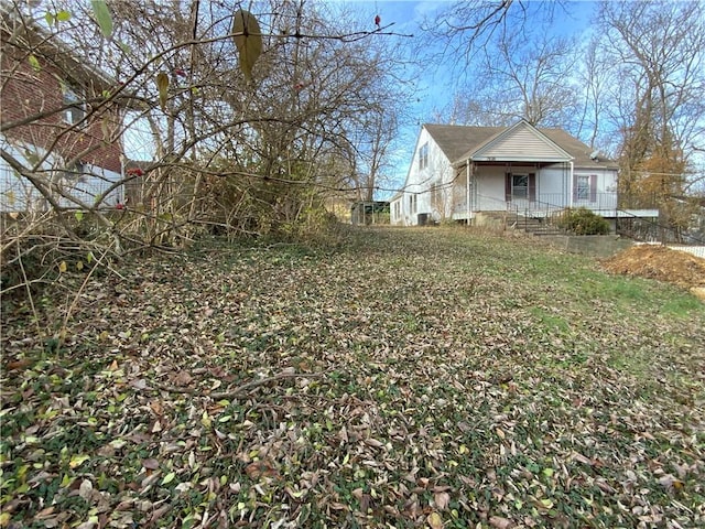 view of yard featuring covered porch