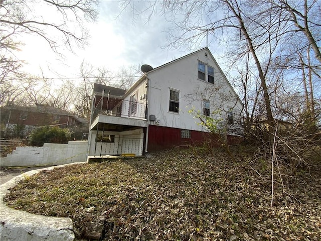 view of home's exterior with a balcony