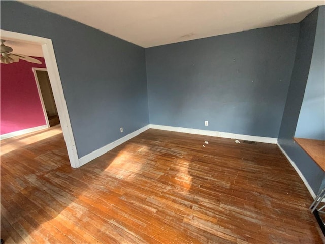 empty room featuring ceiling fan and wood-type flooring