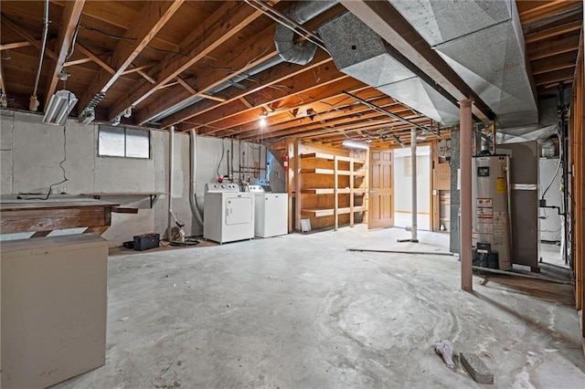 below grade area featuring water heater and washer and clothes dryer