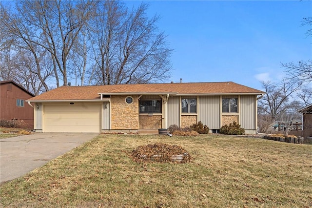 ranch-style home featuring stone siding, a front yard, concrete driveway, and an attached garage