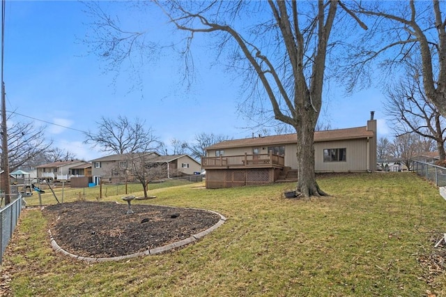 view of yard featuring a residential view, a fenced backyard, and a wooden deck