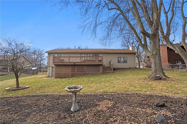 back of property featuring a yard, a chimney, fence, and a deck