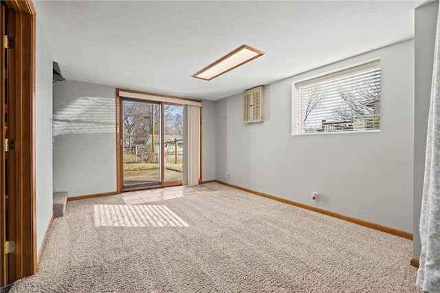 interior space with access to exterior, carpet flooring, baseboards, and multiple windows