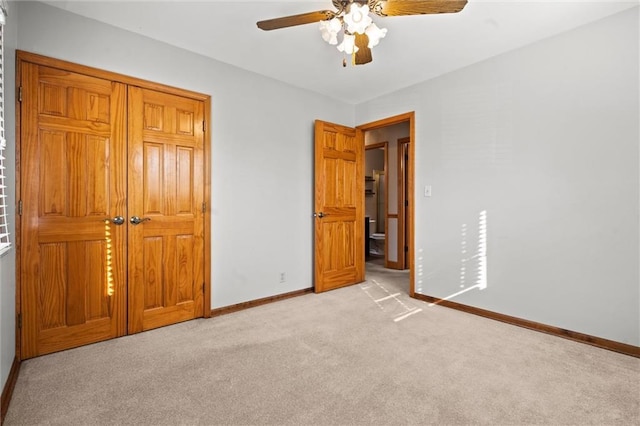 unfurnished bedroom featuring baseboards, a ceiling fan, and light colored carpet