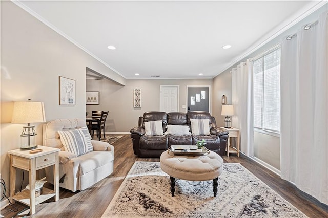 living room featuring ornamental molding, plenty of natural light, and dark hardwood / wood-style flooring