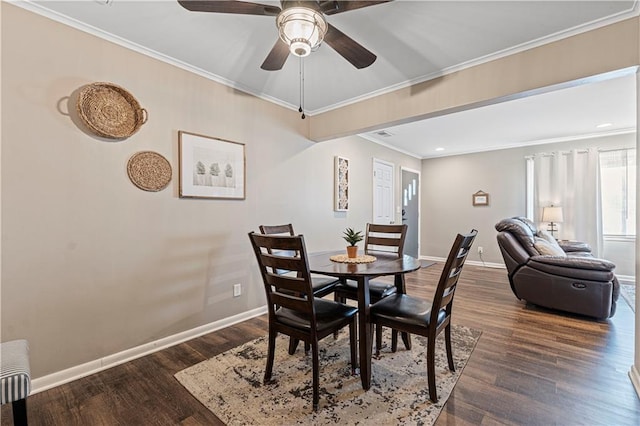 dining room with crown molding, radiator, dark wood-type flooring, and ceiling fan