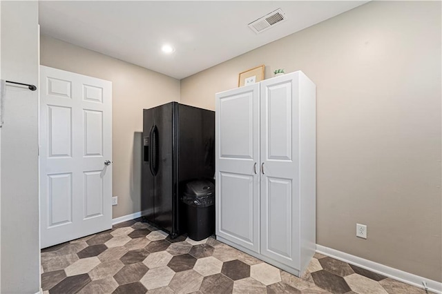 interior space featuring black refrigerator with ice dispenser