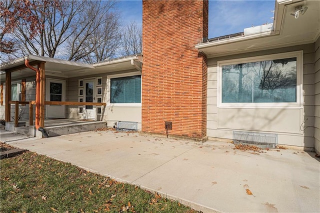 view of side of home with a patio area