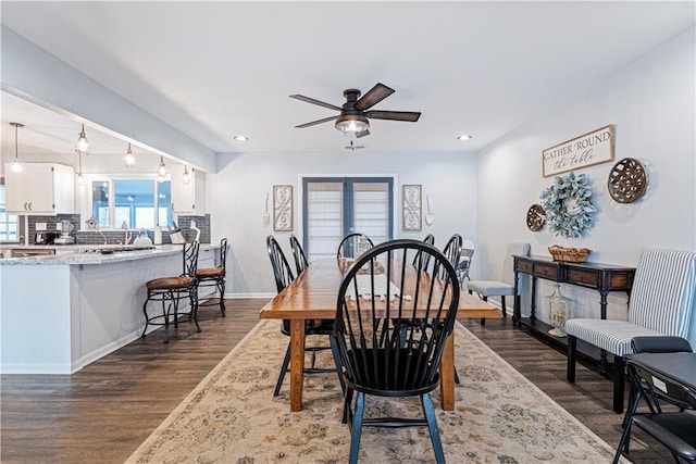 dining area featuring dark hardwood / wood-style flooring, sink, ceiling fan, and french doors