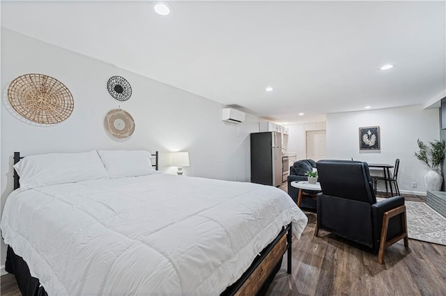 bedroom featuring an AC wall unit, dark hardwood / wood-style floors, and stainless steel refrigerator