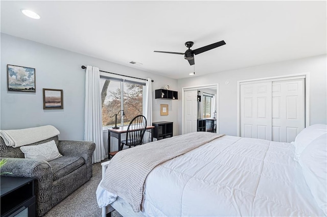 bedroom with multiple closets, ceiling fan, and carpet flooring