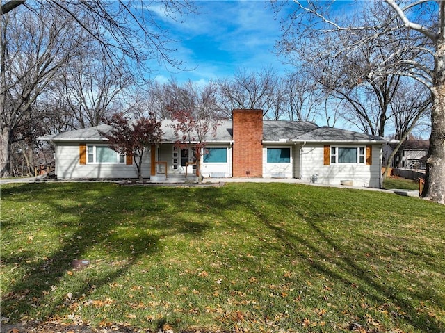 rear view of property with a lawn