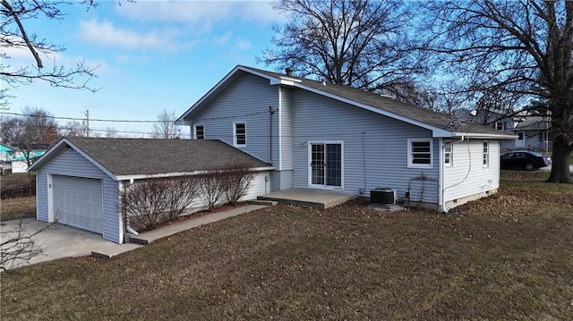 view of side of home featuring a yard, cooling unit, a patio, and a garage