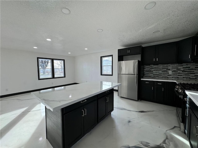 kitchen featuring decorative backsplash, plenty of natural light, a center island, and stainless steel appliances