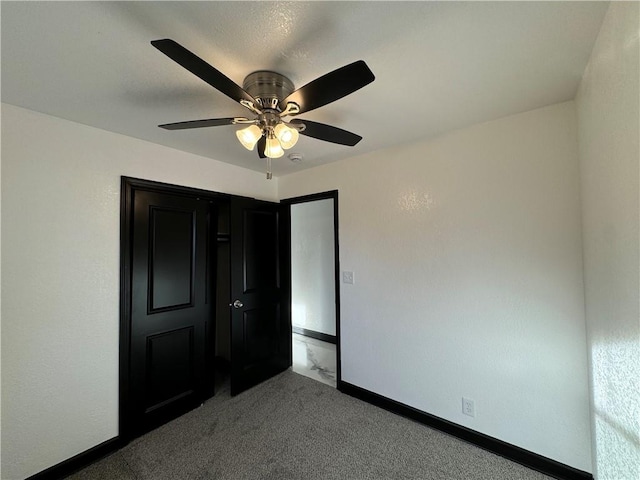 unfurnished bedroom featuring carpet and ceiling fan