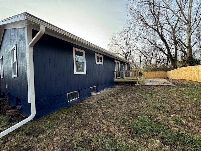 view of property exterior featuring central AC unit, a patio area, and a wooden deck