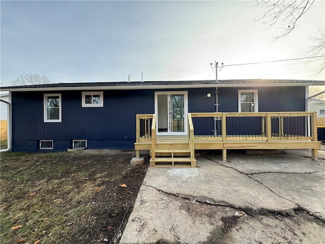 rear view of house with central air condition unit and a deck